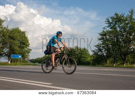 Man Cycling At The Road