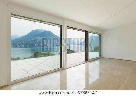 Interior, modern penthouse, empty living room with large windows