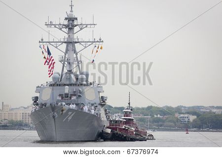 STATEN ISLAND, NY - MAY 21, 2014: The guided-missile destroyer USS McFaul (DDG 074) is guided into port at Sullivans Piers on May 21, 2014. The ship is part of Fleet Week NY.