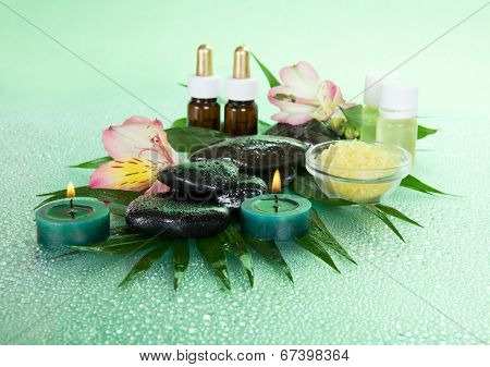 Aromatic oil, salt, candles, stones and flower