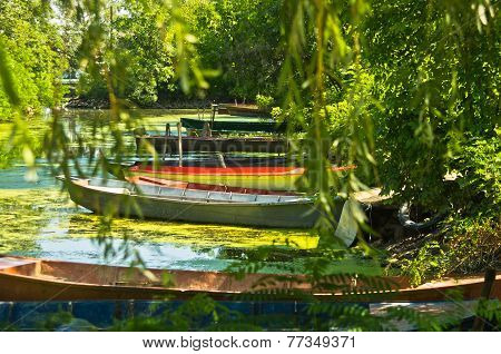 Colorful old fisherman boats in shadow at Danube river