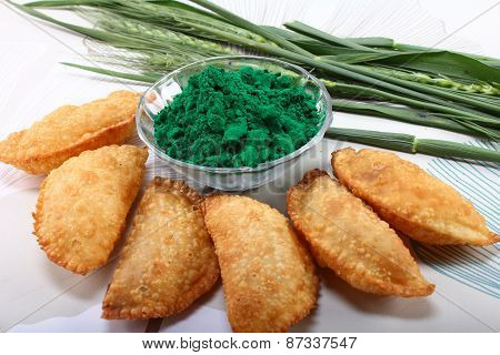 Gujia In Plate With Holi Green Color In Bowl