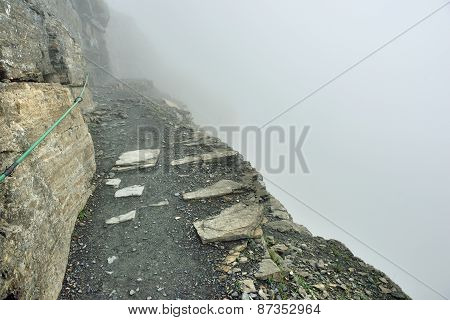 High And Steep Alpine Trail And Heavy Fog In Glacier National Park