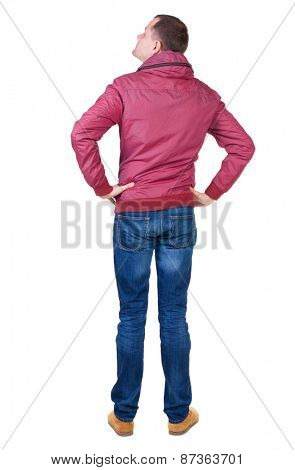 Back view of handsome man in brown windcheater looking up.   Standing young guy in jeans. Rear view people collection.  backside view of person.  Isolated over white background.
