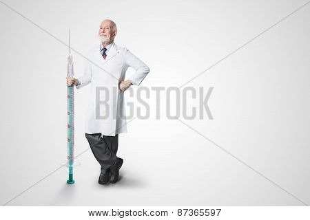 friendly male doctor with huge syringe