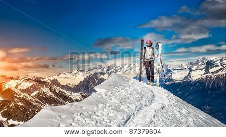 Girl In Top Of The Mountain On Skis In Hand