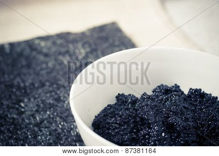 Fresh black caviar in a bowl to make sushi and fish dishes
