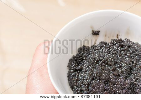 Fresh black caviar in a bowl to make sushi and fish dishes