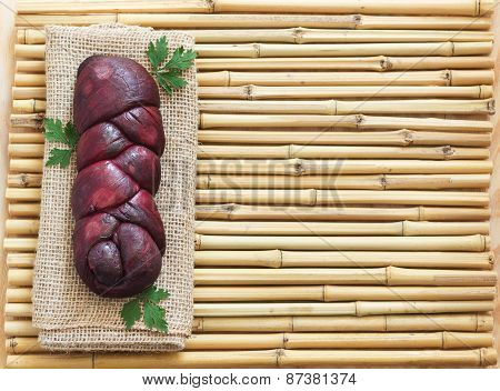 Homemade Braided Mozzarella Marinated In Red Wine On Sackcloth, Bamboo Board