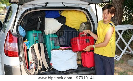 Child Loads Beautycase In The Baggage Car In Summer