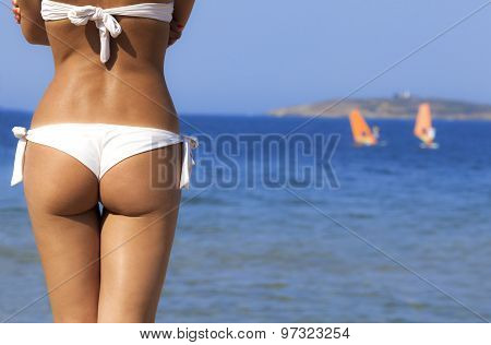 Beautiful girl buttocks on a blue sea background