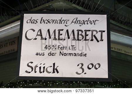 Munich, Germany - June 04, 2015: Sign of a sales stall at Viktualienmarkt showing Camembert cheese offer for 3 Euros each