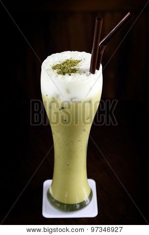 Iced Green tea latte on black background. Close-up