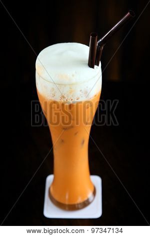 Thai style iced tea latte on black background, Close-up