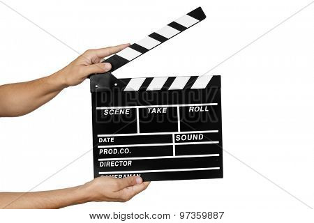 closeup of a young man about to clap a traditional wooden clapperboard against a white background