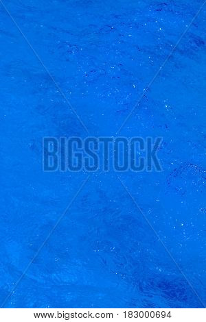 Clear background swimming pool rippled water detail.