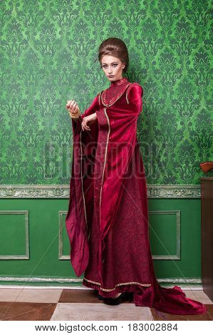 Gorgeous woman dressed in vintage clothes in retro interior. Rococo period. Luxury and high class