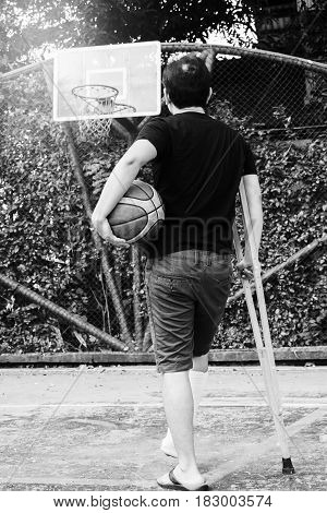Man Standing With Broken Leg In Plaster Cast Using Crutches