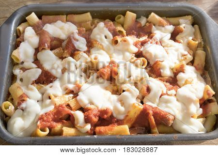 baking tray of baked pasta with mozzarella