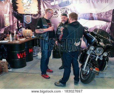 St. Petersburg Russia - 15 April, Bikers with beer at the exhibition,15 April, 2017.
International Motor Show IMIS-2017 in Expoforurum.
Visitors and participants of the annual moto-salon in St. Petersburg.
