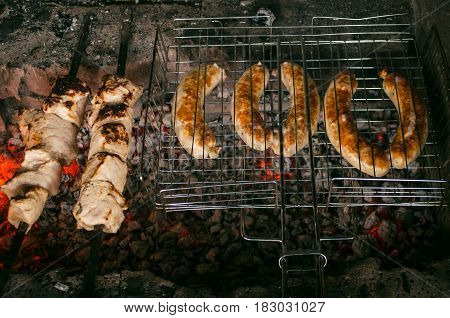 Barbecue meat steaks on the grill with flames. Meat on the coals. barbecue vacation concept close up.