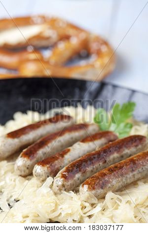 nuremberg bratwurst on cabbage in a pan