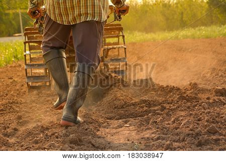 Man working in the garden with garden tiller. Garden tiller to work.