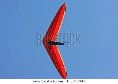 Hang Glider flying in in a blue sky