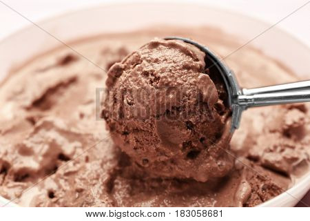 Scoop with delicious chocolate ice cream ball, closeup