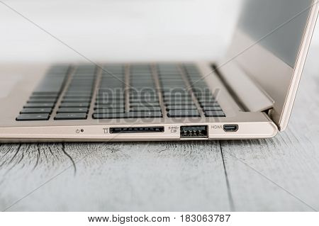 Ultra-thin notebook. The silver notebook on the desk the open notebook lies on a wooden background.