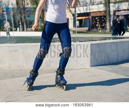 young Roller Girl is learning how to skate. First time on roller skates. Turning left