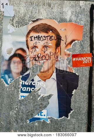 STRASBOURG FRANCE - APR 26 2017: Official campaign posters of Emmanuel Macron political party leader of En marche ! (EM !) vandalized on the first round of 2017 French presidential election