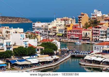 AGHIOS NIKOLAOS, CRETE, GREECE - AUGUST 2016: Small harbor with moored fishing boats at Aghios Nikolaos town on Crete island, Greece