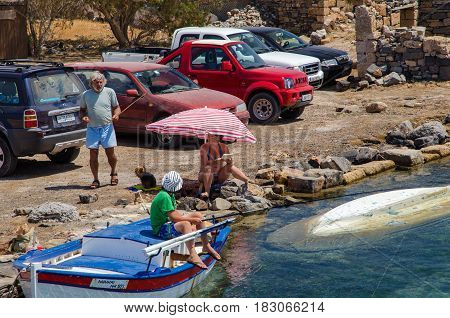 AGHIOS NIKOLAOS, CRETE, GREECE - AUGUST 2016: Greek family is having vacation at coast of Crete island.