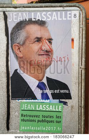 STRASBOURG FRANCE - APR 26 2017: Official campaign posters of Jean Lassalle political party leader of Resistons vandalized on the first round of 2017 French presidential election