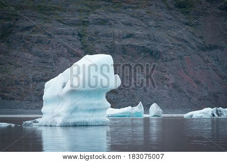 Evening landscape with ice floes in the glacial lake Fjallsarlon. Vatnajokull National Park, Iceland, Europe. Amazing tourist attraction