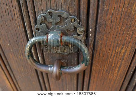 handle door rusty iron ring in wood doorway