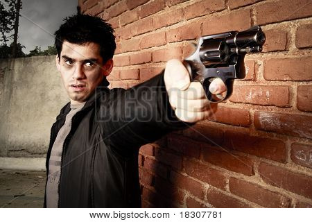 Mand med pistol i en gyde
