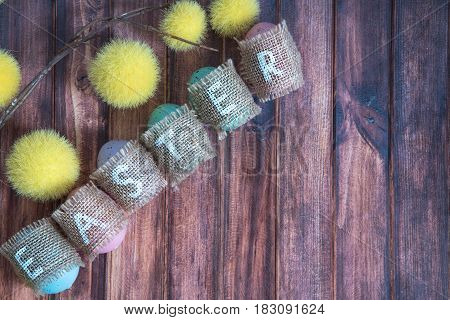 easter background with colored eggs yellow branches and copy space