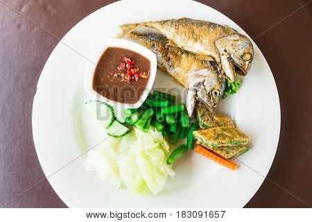 Top down shot of authentic traditional thai food with fry mackerel spice vegetable carrot on white plate for healthy eating food restaurant diet happy thai lunch meal concepts background