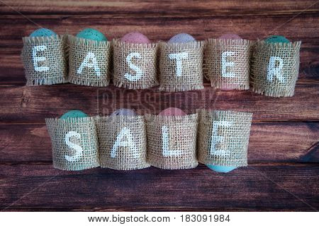 Easter concept: inscription Easter sale consisting on sacking. On wooden background waith copy space