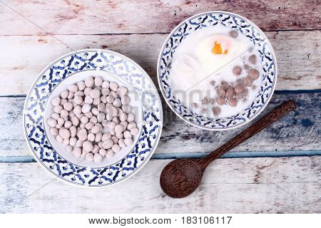 Purple Potato Dumplings With Poached Egg And Coconut Roll In Sweet Coconut Cream .