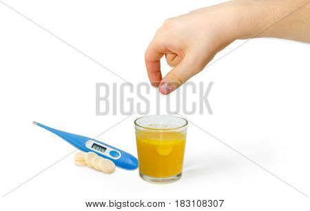 Effervescent medicinal tablet thrown into the glass of water by human hand several same tablets separately beside and blue electronic clinical thermometer on a light background
