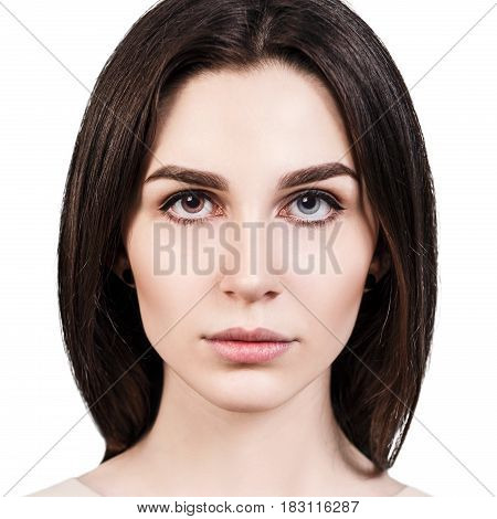 Portrait of young beautiful girl with heterochromia over white background