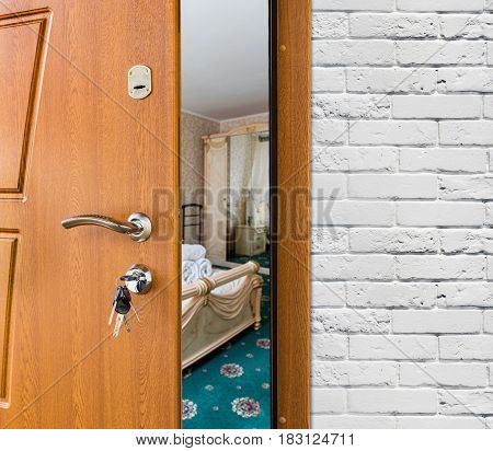 Half opened door to a bedroom, handle closeup. Welcome, privacy concept. Entrance to the hotel suit, modern interior design.