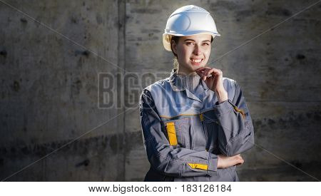 Cheerful female worker at a construction doing its job