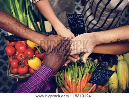 Hands stack for support power at grocery shio