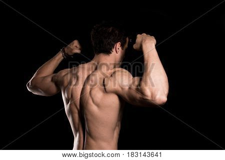 Sexy Shirtless Muscular Male Model on black background.
