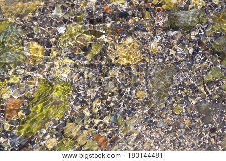 Lake Bed Of Rocks Or Pebbles Under Water.
