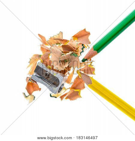 Two Wooden Colour Pencils, Metal Sharpener And Pencil Shavings.